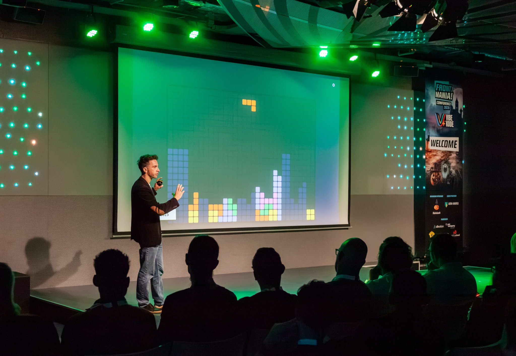Speaking at Frontmania with a colourful Tetris game projected behind me